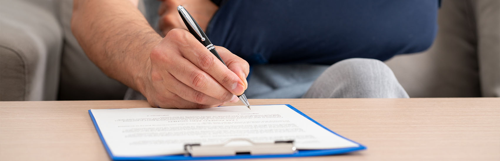 Injured person filling out paperwork.